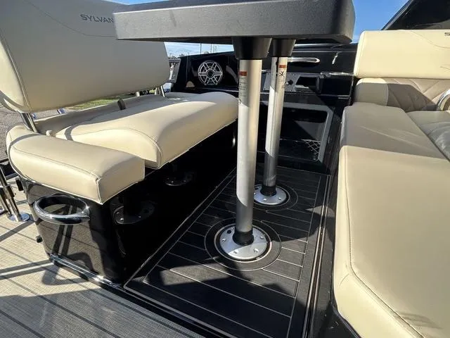 Slide: The Image of 2024 Sylvan M3 DLZ boat interior with beige seating and table. - 41