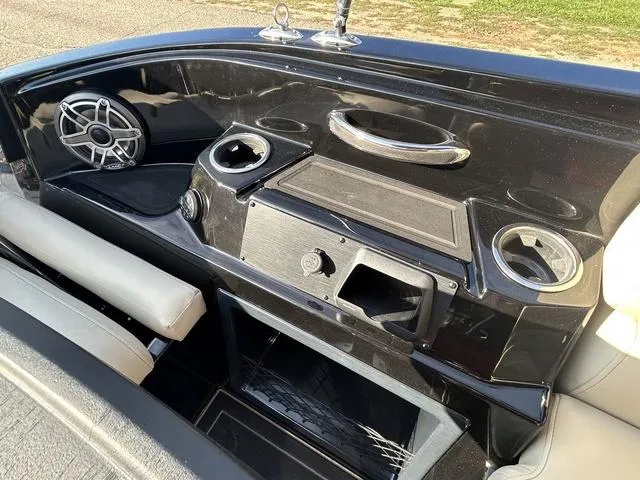 Slide: The Image of 2024 Sylvan M3 DLZ boat dashboard with speaker, cup holders, and storage compartments. - 42