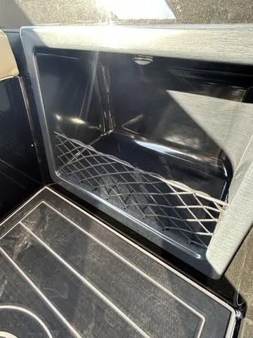 Slide: The Image of 2024 Sylvan M3 DLZ boat storage compartment with netting. - 43