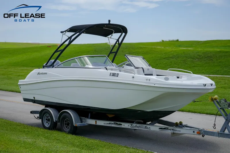 Slide: The Image of 2020 Hurricane 217 SD boat on trailer with black canopy, displayed by Off Lease Boats. - 0