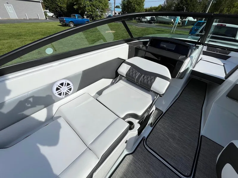 Slide: The Image of 2024 Monterey M-205 boat interior with white and gray seating. - 12