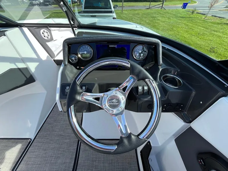Slide: The Image of 2024 Monterey M-205 boat dashboard with steering wheel and instrument panel. - 16