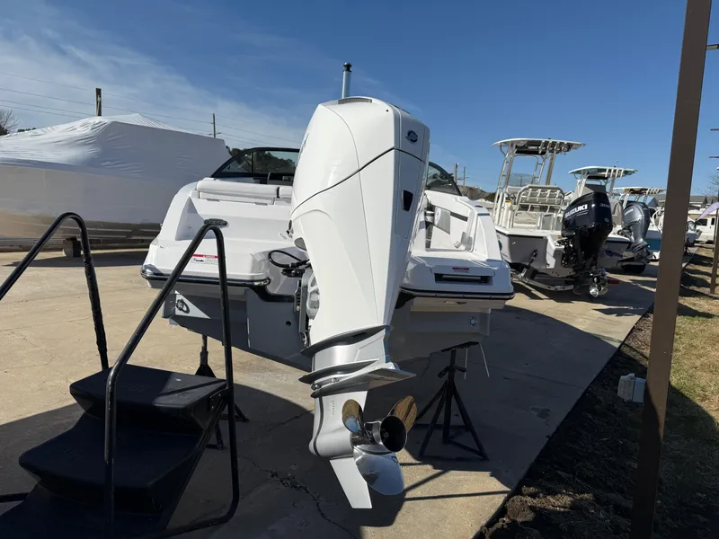 Slide: The Image of 2024 Monterey M-205 boat with powerful outboard motor displayed outdoors. - 2