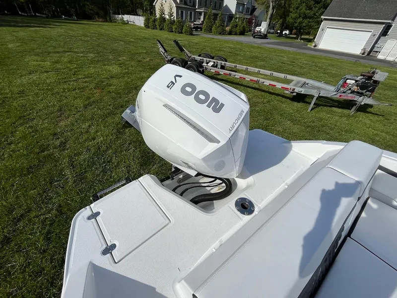 Slide: The Image of 2024 Monterey M-205 boat with a powerful outboard motor on a grassy lawn. - 5