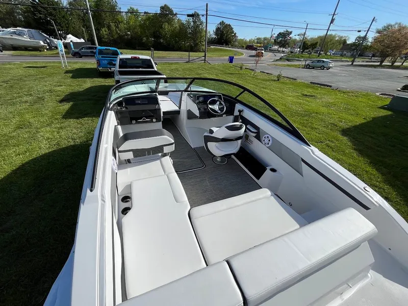 Slide: The Image of 2024 Monterey M-205 boat interior with seating and steering wheel, parked on grass. - 7