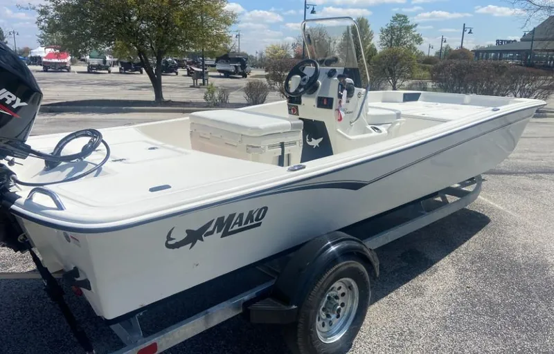 Slide: The Image of 2024 Mako Pro Skiff 17 CC boat on trailer in parking lot. - 4