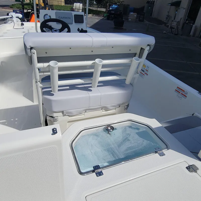 Slide: The Image of 2024 Mako Pro Skiff 19 CC boat interior with seating and livewell. - 6