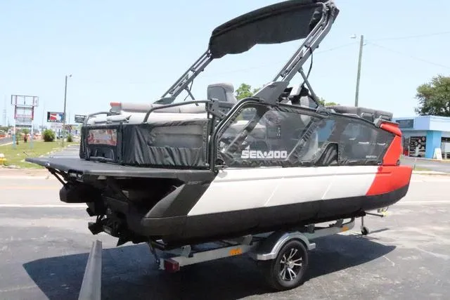 Slide: The Image of 2024 Sea-Doo Switch® Cruise 18 on trailer, 230 hp, galvanized model, parked outdoors. - 6