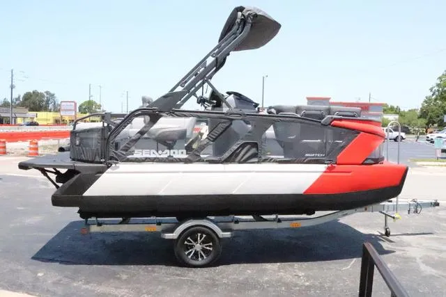 Slide: The Image of 2024 Sea-Doo Switch® Cruise 18 - 230 hp Galvanized pontoon boat on trailer, side view. - 7