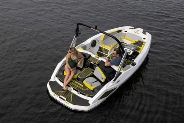 Slide: The Image of 2023 Scarab 165 ID boat on water with two people relaxing onboard. - 10
