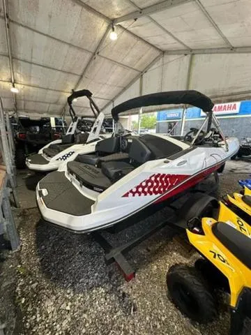 Slide: The Image of 2023 Scarab 165 ID boat displayed in a showroom with other vehicles. - 3