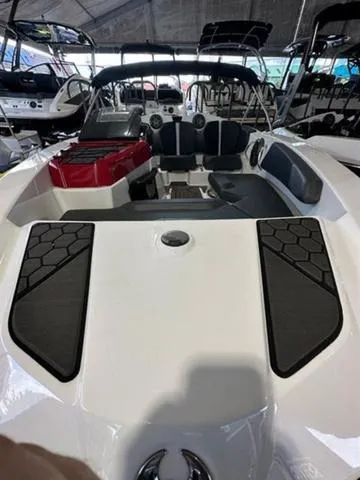 Slide: The Image of 2023 Scarab 165 ID boat interior with seating and dashboard in showroom. - 6