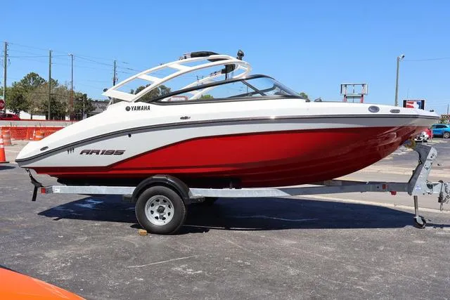 Slide: The Image of 2024 Yamaha AR195 boat engine compartment with SYHO engine, white and gray interior. - 7