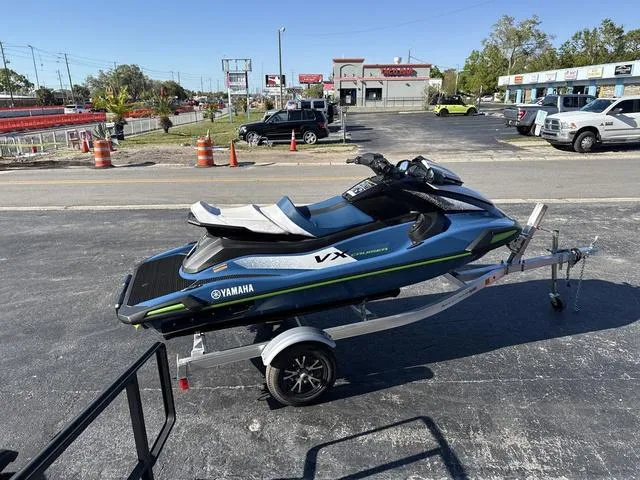 Slide: The Image of 2024 Yamaha Marine Waverunner VX Cruiser in Deepwater Blue on trailer, parked outdoors. - 11