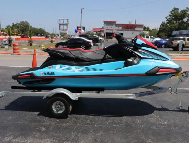 Slide: The Image of 2024 Yamaha Marine Waverunner VX Deluxe with audio, cyan color, open storage compartment. - 6