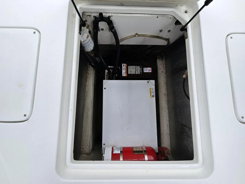 Slide: The Image of 2007 Cobalt 323 engine compartment with fire extinguisher and mechanical components. - 10