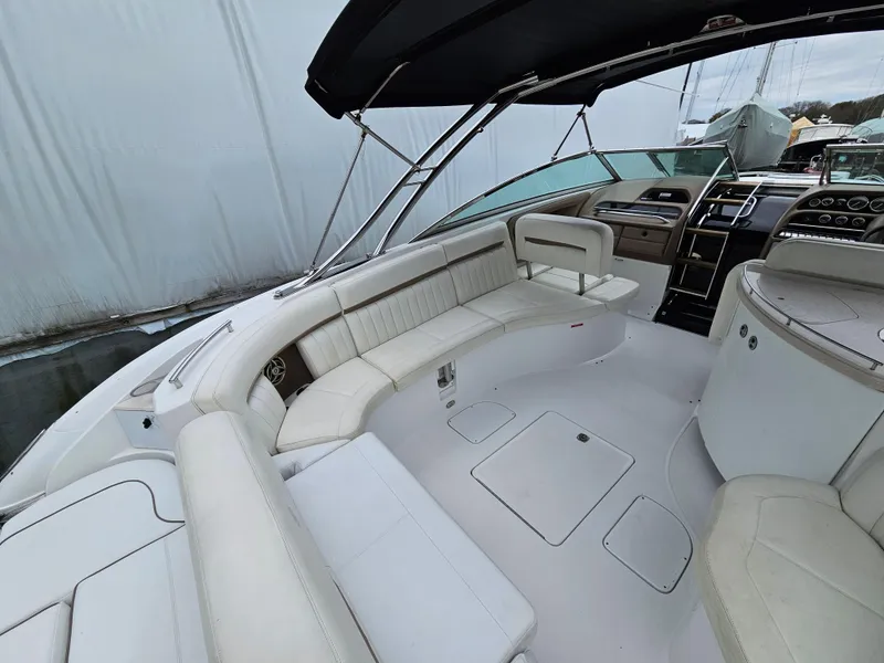 Slide: The Image of 2007 Cobalt 323 boat interior with white seating and black canopy. - 3