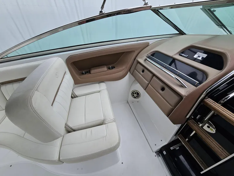 Slide: The Image of Interior of a 2007 Cobalt 323 boat with white leather seating and dashboard. - 5