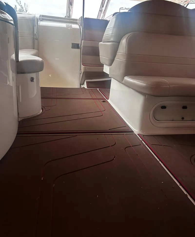 Slide: The Image of Interior of a 2009 Formula 400 Super Sport boat with brown flooring and beige seating. - 14