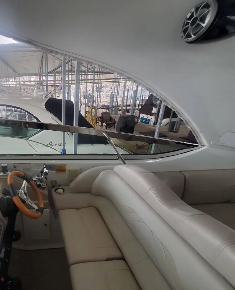 Slide: The Image of Interior of a 2009 Formula 400 Super Sport yacht with beige seating and steering wheel. - 15