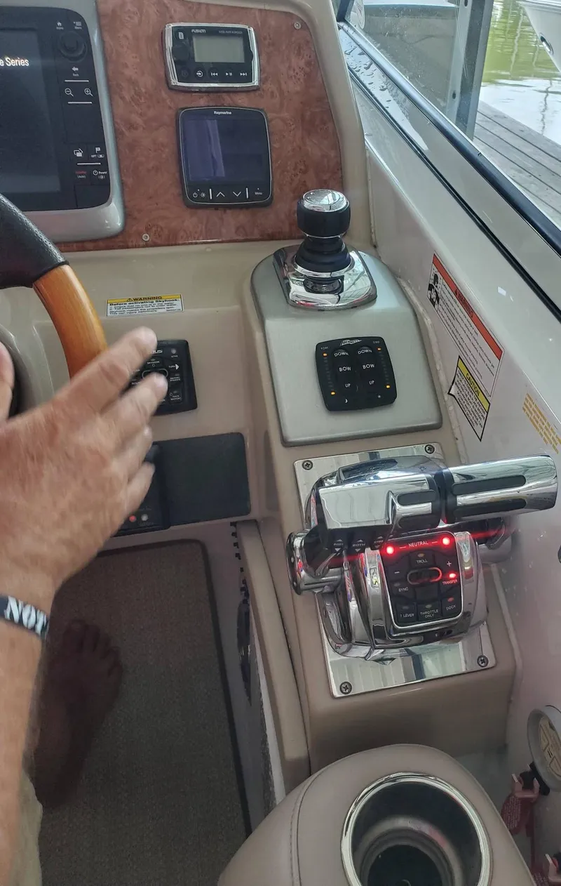 Slide: The Image of Control panel of a 2009 Formula 400 Super Sport boat with throttle and joystick. - 18