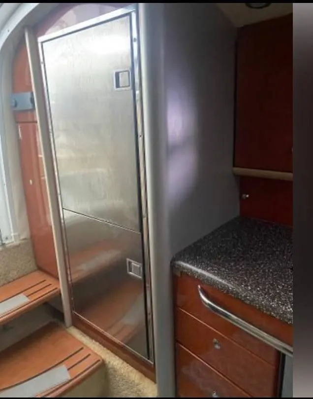 Slide: The Image of 2009 Formula 400 Super Sport yacht interior with stainless steel fridge and wooden cabinetry. - 22