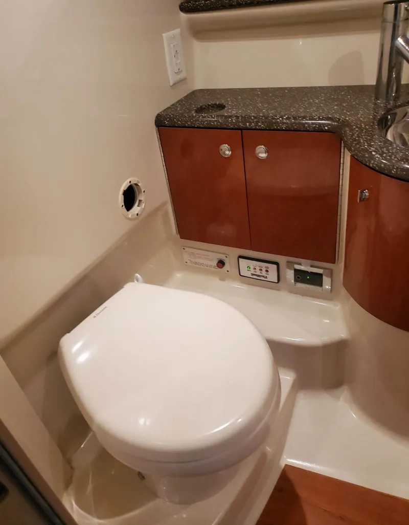 Slide: The Image of 2009 Formula 400 Super Sport boat bathroom with toilet and storage cabinets. - 27