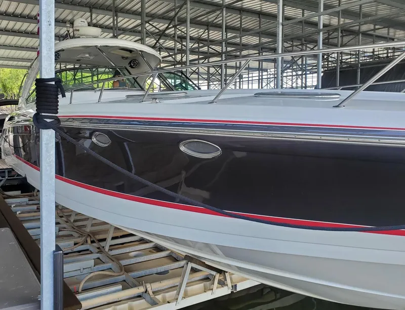 Slide: The Image of 2009 Formula 400 Super Sport boat docked in a covered marina. - 5