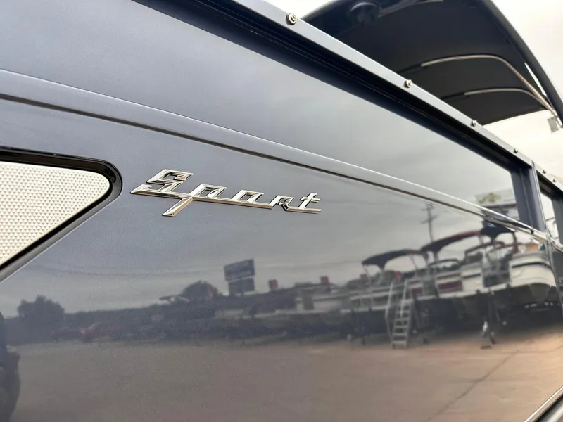 Slide: The Image of 2024 Bennington 23 RXSBA boat with "Sport" emblem, sleek design in a marina setting. - 10