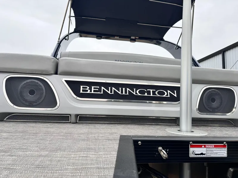 Slide: The Image of 2024 Bennington 23 RXSBA boat with speakers and branding on deck. - 12