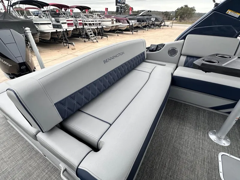 Slide: The Image of 2024 Bennington 23 RXSBA boat interior with luxurious seating and cup holders. - 18