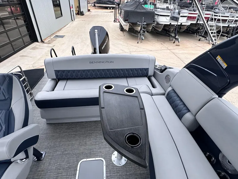 Slide: The Image of 2024 Bennington 23 RXSBA pontoon boat interior with seating and table. - 21