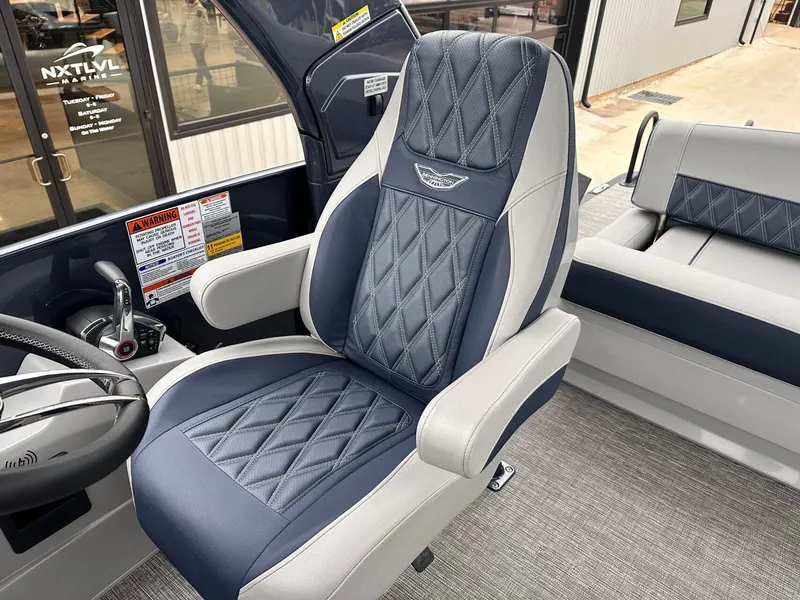 Slide: The Image of 2024 Bennington 23 RXSBA boat seat with diamond-stitched upholstery and armrests. - 22