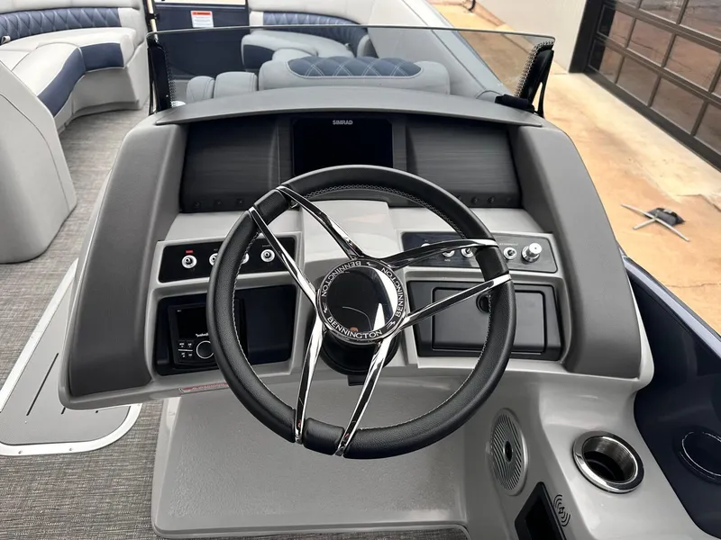 Slide: The Image of 2024 Bennington 23 RXSBA boat dashboard with steering wheel and controls. - 23