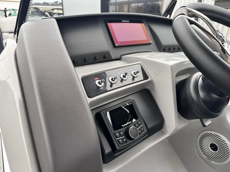 Slide: The Image of 2024 Bennington 23 RXSBA boat dashboard with steering wheel and control panel. - 24