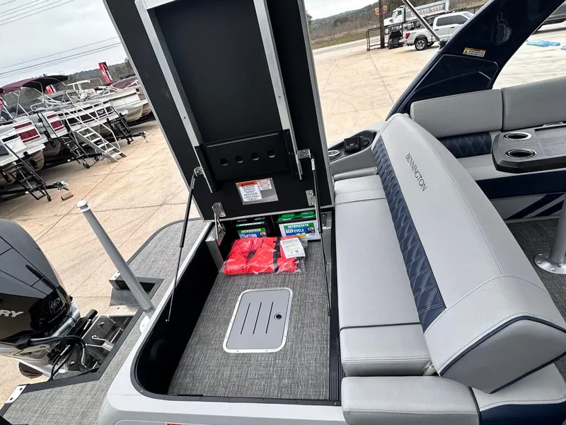 Slide: The Image of 2024 Bennington 23 RXSBA boat interior with storage compartment and seating area. - 32