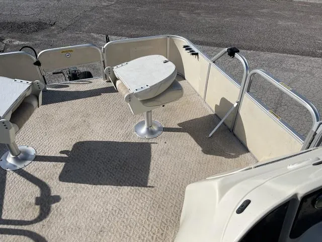 Slide: The Image of 2006 Godfrey Parti Kraft 1980F pontoon boat interior with seating and table. - 10