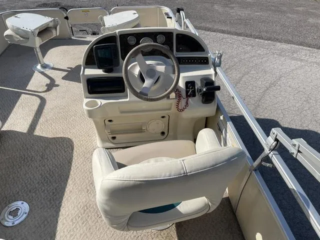 Slide: The Image of 2006 Godfrey Parti Kraft 1980F boat helm with steering wheel and control panel. - 8