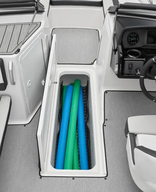 Slide: The Image of 2024 Yamaha AR195 boat interior with storage compartment and pool noodles. - 4