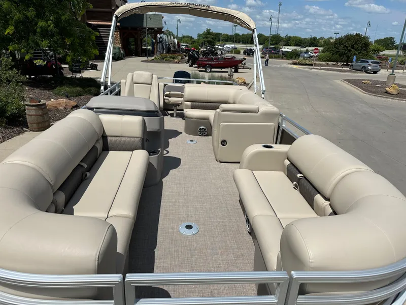 Slide: The Image of 2024 Sun Tracker SportFish 22 DLX pontoon boat with spacious seating and beige upholstery. - 3