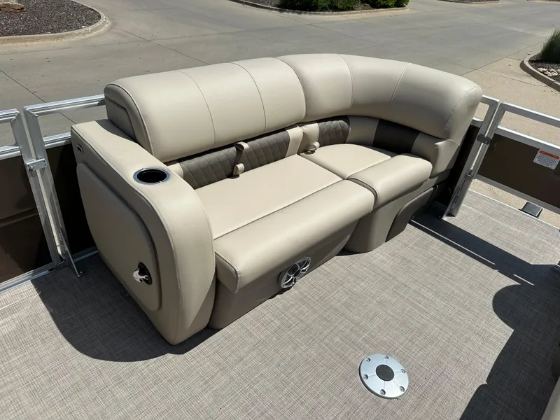 Slide: The Image of 2024 Sun Tracker SportFish 22 DLX pontoon boat with beige seating and cup holder. - 4