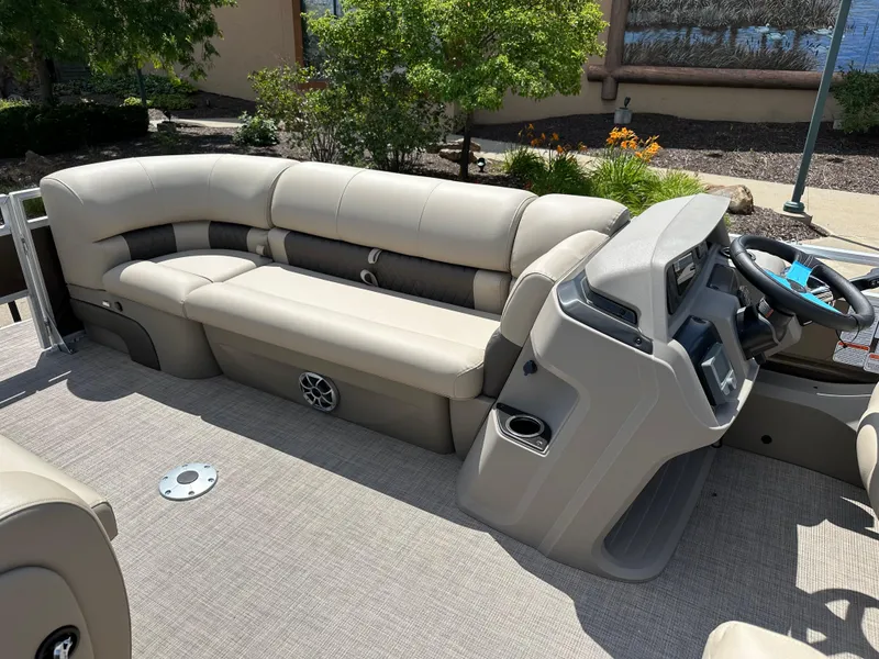Slide: The Image of 2024 Sun Tracker SportFish 22 DLX pontoon boat interior with beige seating and modern console. - 5