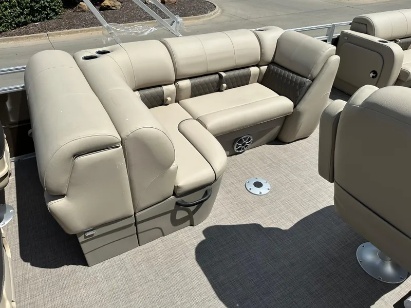 Slide: The Image of 2024 Sun Tracker SportFish 22 DLX pontoon boat with beige seating and carpeted deck. - 7