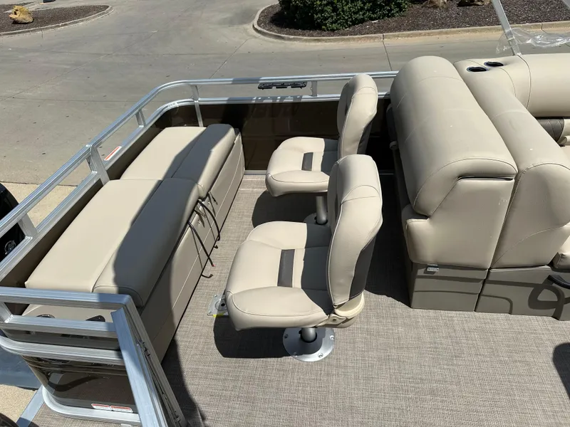 Slide: The Image of 2024 Sun Tracker SportFish 22 DLX boat interior with beige seating and carpeted floor. - 8