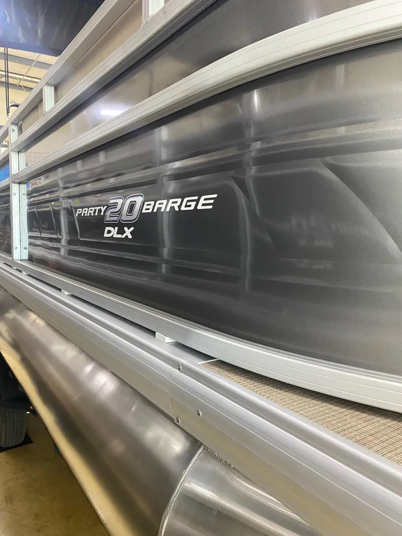 Slide: The Image of 2024 Sun Tracker Party Barge 20 DLX pontoon boat side view. - 2