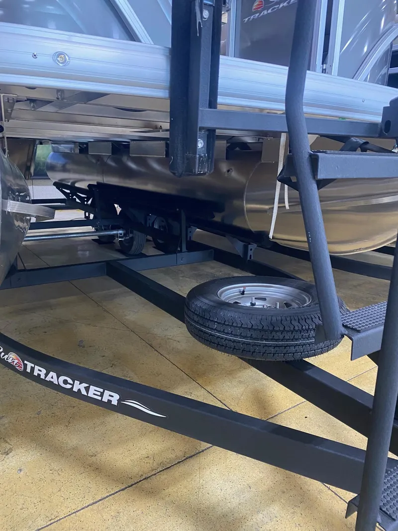 Slide: The Image of 2024 Sun Tracker Party Barge 20 DLX trailer with spare tire, close-up view. - 9
