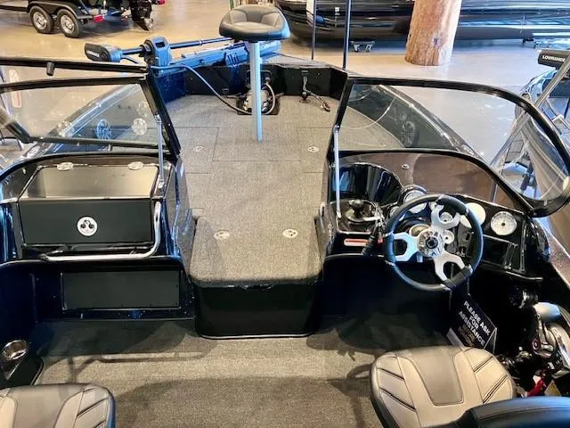 Slide: The Image of 2024 Nitro ZV19 Sport Pro boat interior with steering wheel and seating. - 2