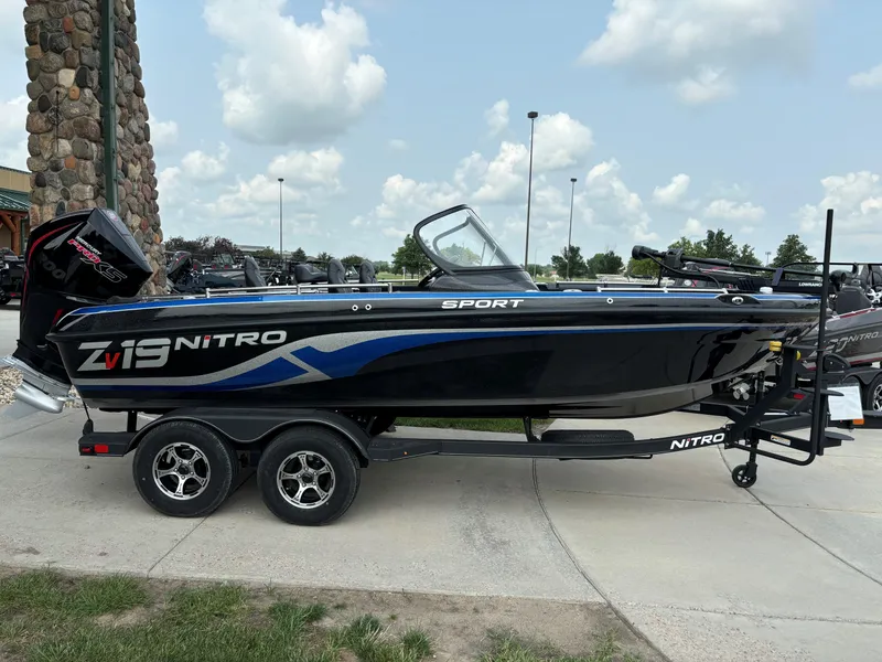 Slide: The Image of 2024 Nitro ZV19 Sport Pro boat on a trailer, parked outdoors. - 1