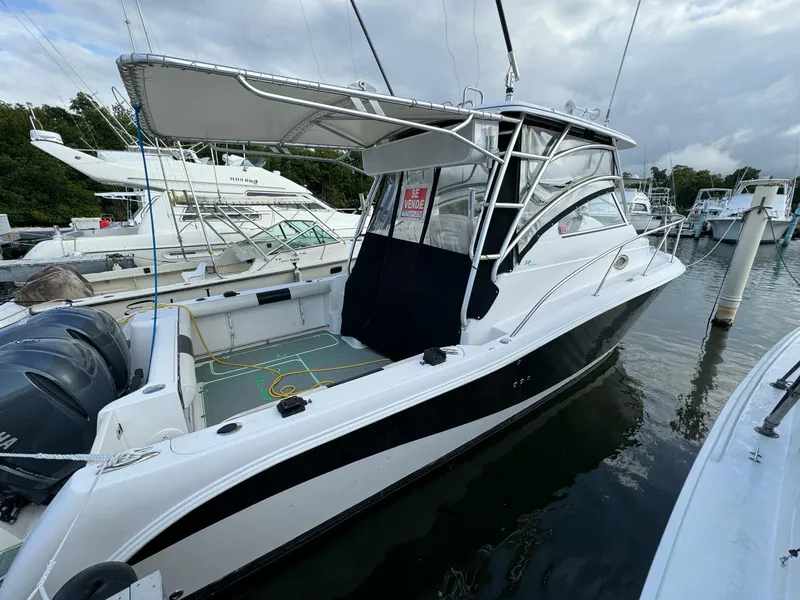 The Image of 2006 Pro-Line 32 Express boat docked at marina, featuring sleek design and spacious deck. - 1