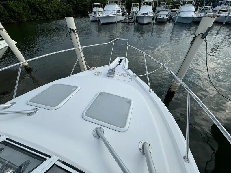 Slide: The Image of 2006 Pro-Line 32 Express boat docked, view from bow, surrounded by water and other boats. - 11